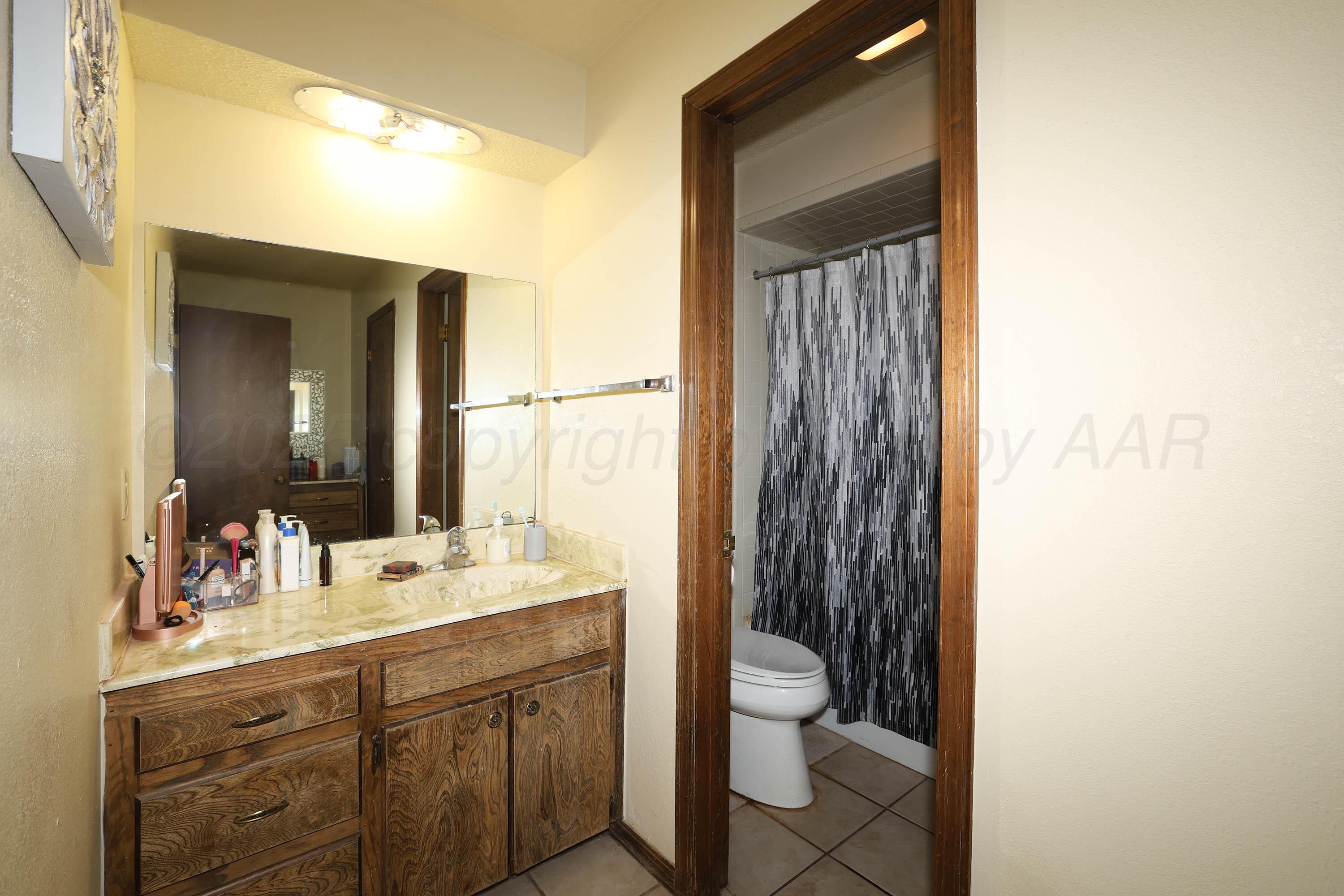 6225-6227 Belpree Road Amarillo, TX 79106 - Photo 11 of 31 a bathroom with a double vanity sink toilet and shower