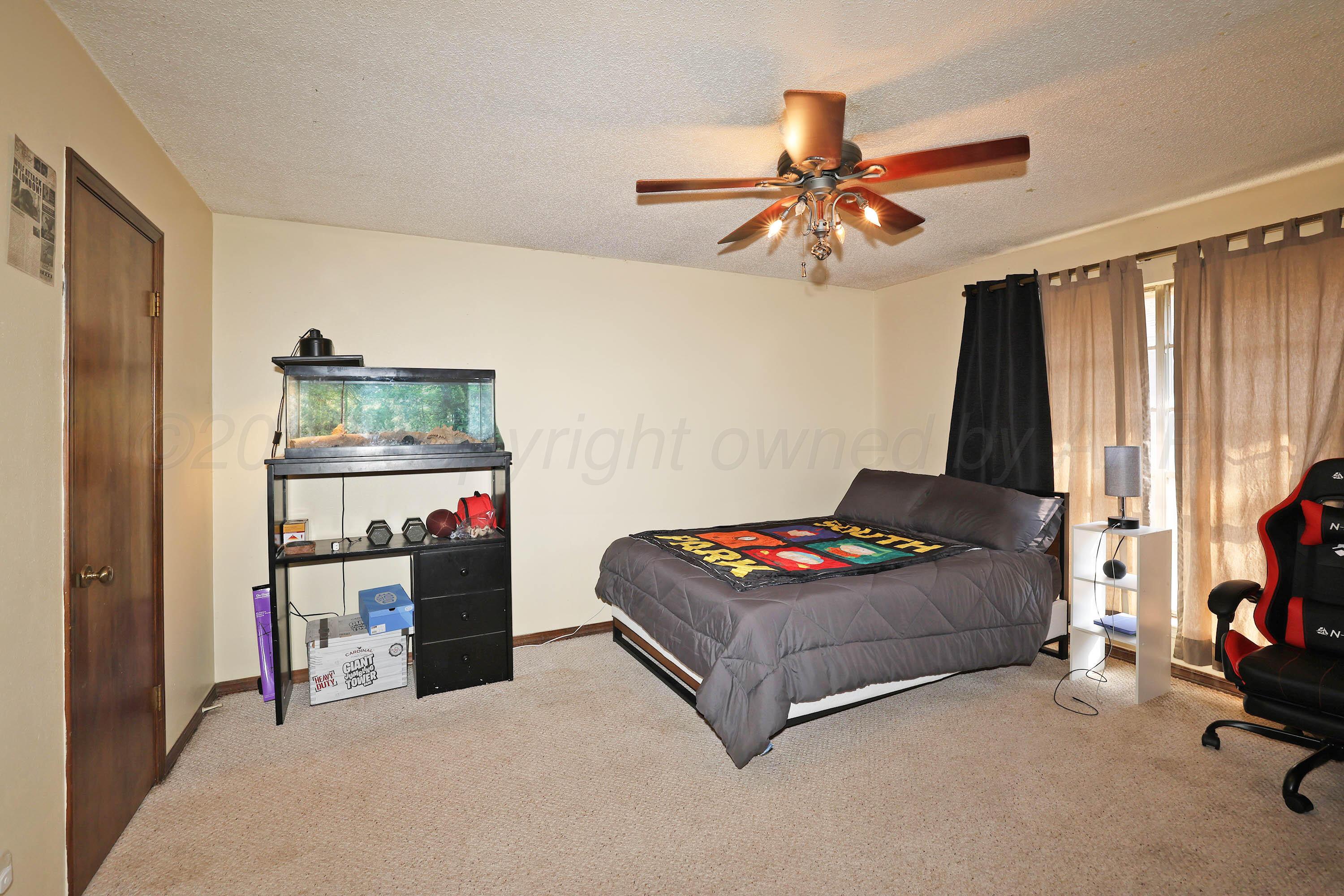 6225-6227 Belpree Road Amarillo, TX 79106 - Photo 12 of 31 a living room with hard wood floor and gym equipment