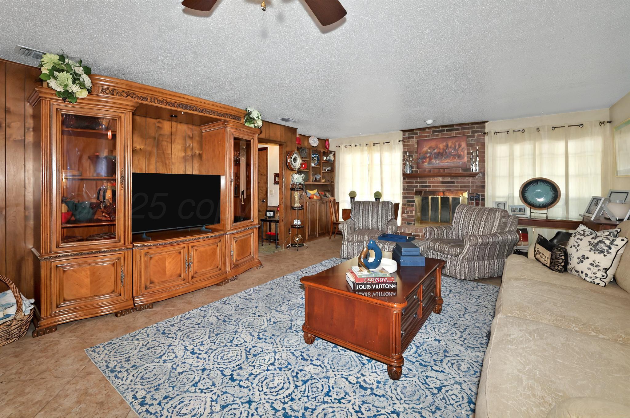 6225-6227 Belpree Road Amarillo, TX 79106 - Photo 19 of 31 a living room with fireplace furniture and a flat screen tv