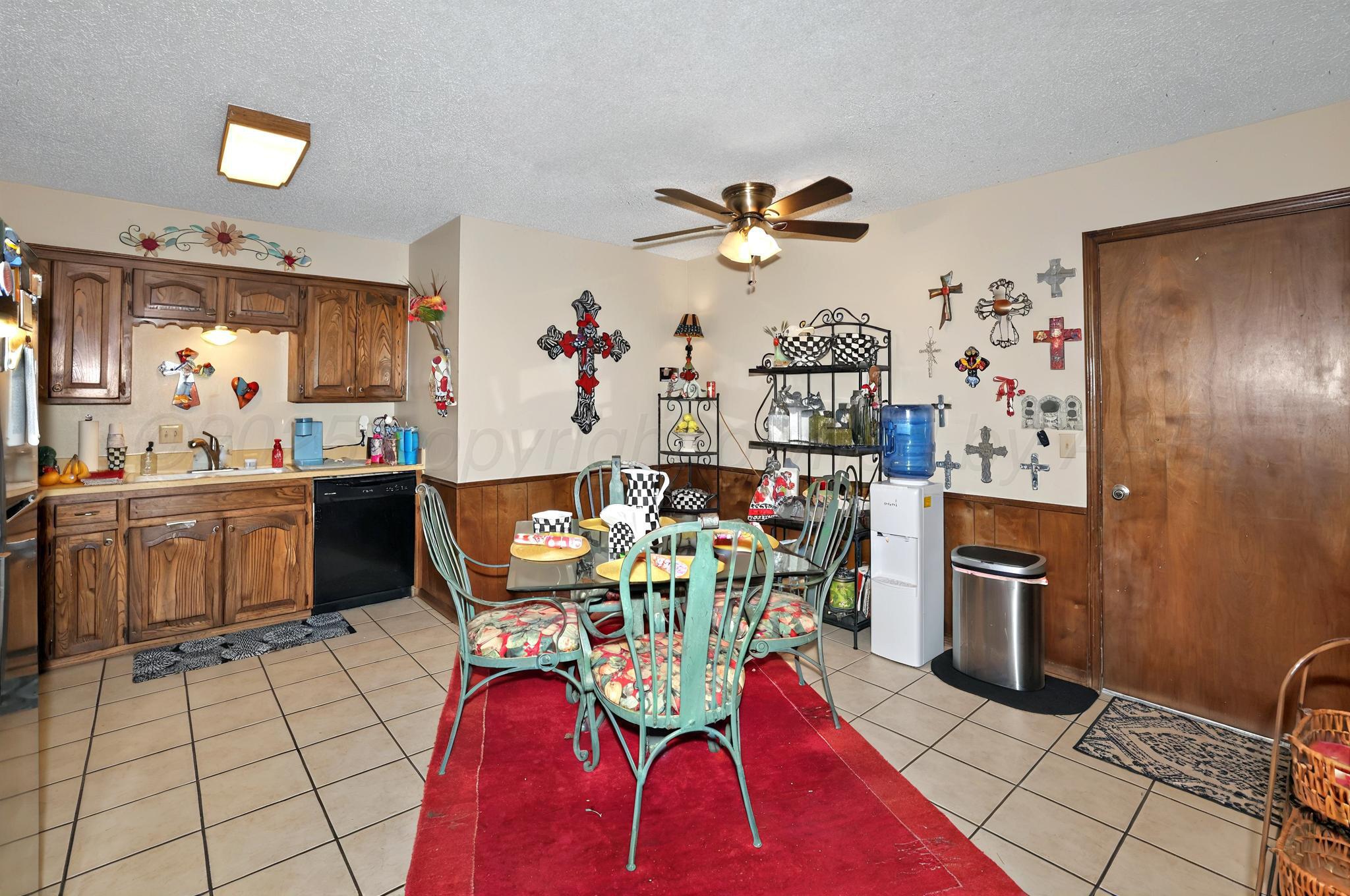 6225-6227 Belpree Road Amarillo, TX 79106 - Photo 21 of 31 a view of a dining room with furniture a chandelier and wooden floor