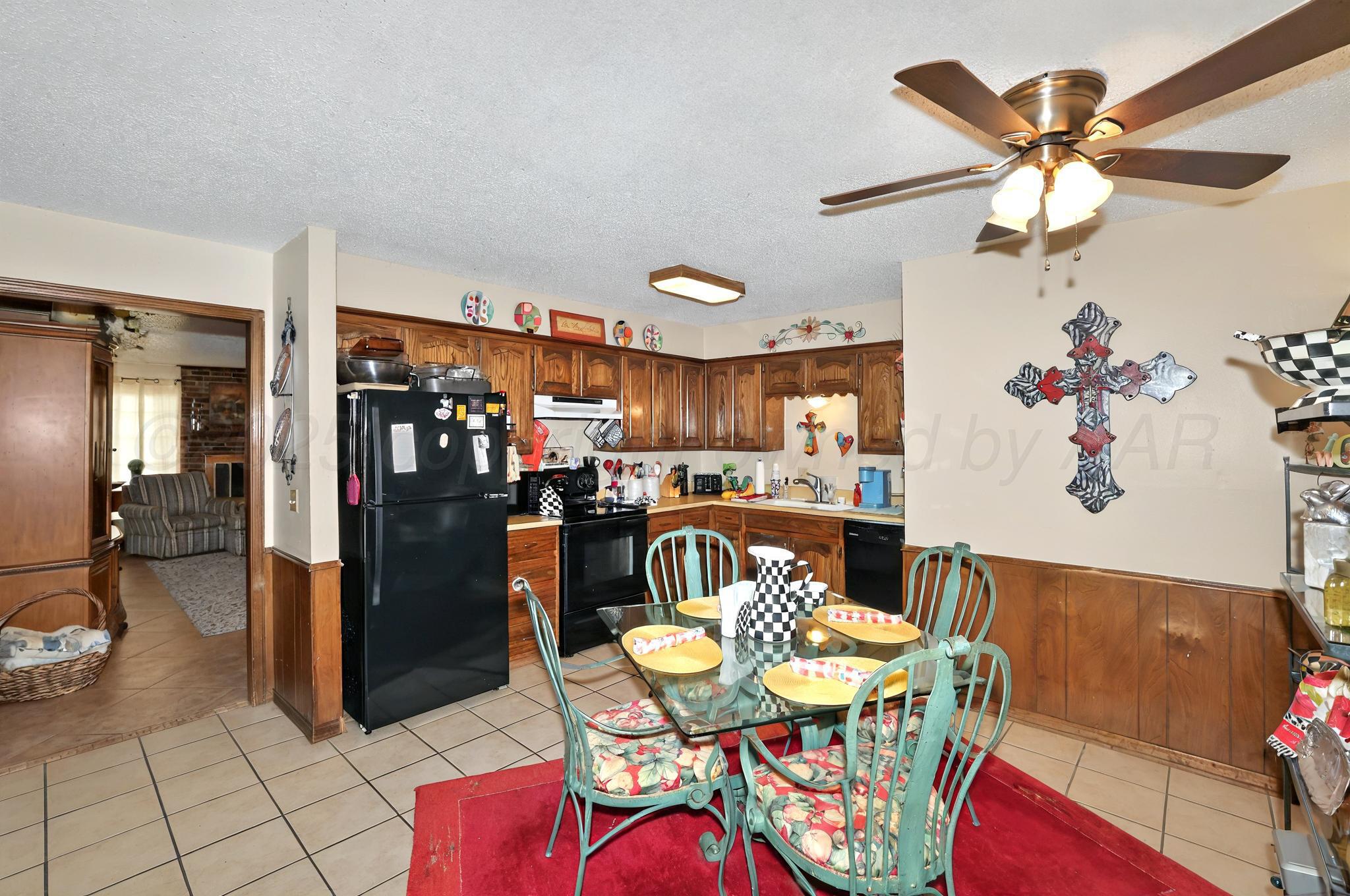 6225-6227 Belpree Road Amarillo, TX 79106 - Photo 22 of 31 a dining room with furniture and kitchen view