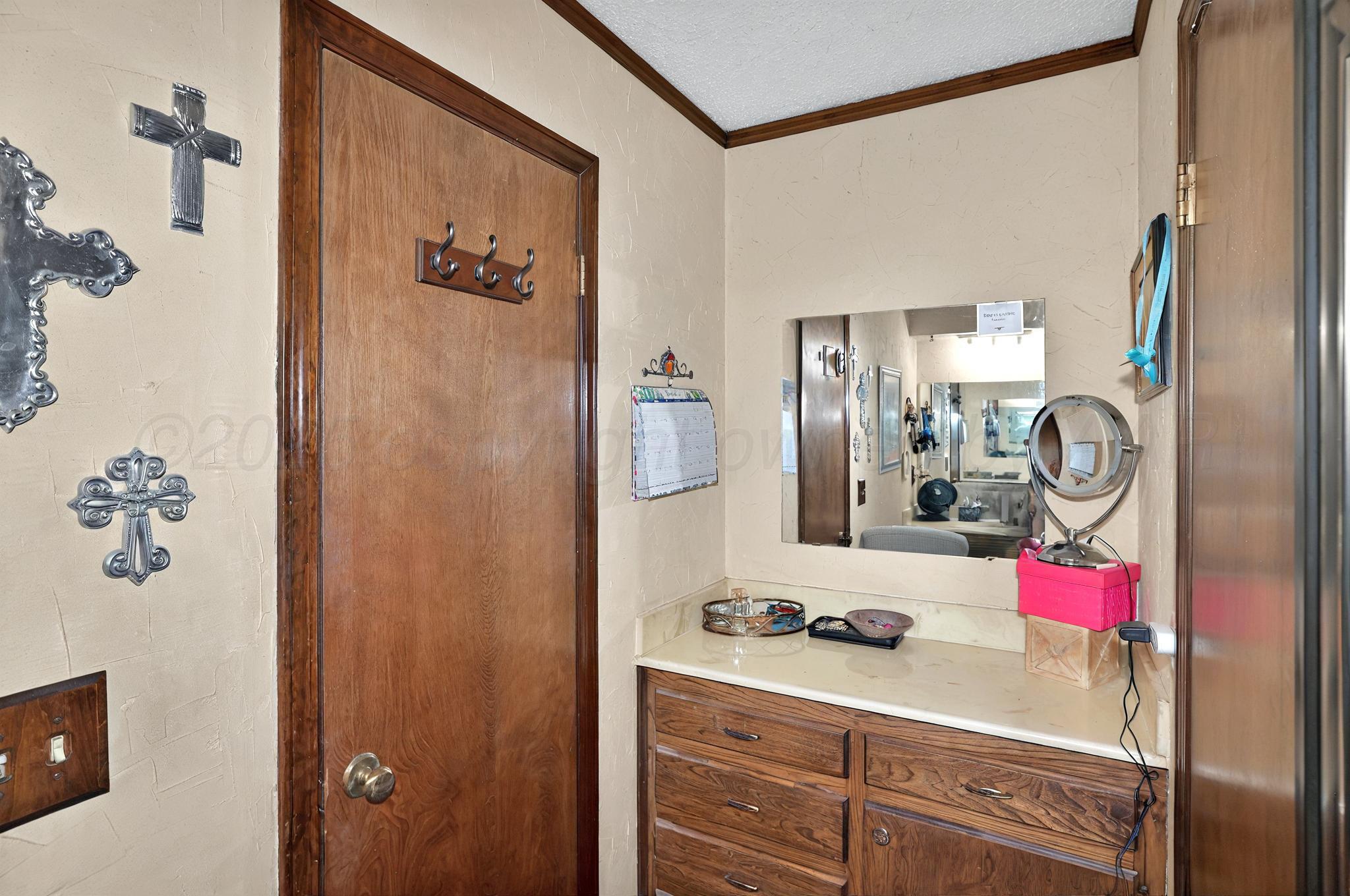 6225-6227 Belpree Road Amarillo, TX 79106 - Photo 27 of 31 a bathroom with a sink and a mirror