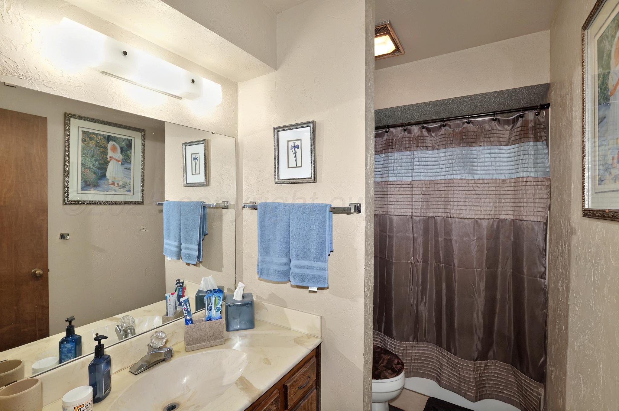 6225-6227 Belpree Road Amarillo, TX 79106 - Photo 29 of 31 a bathroom with a sink and a mirror