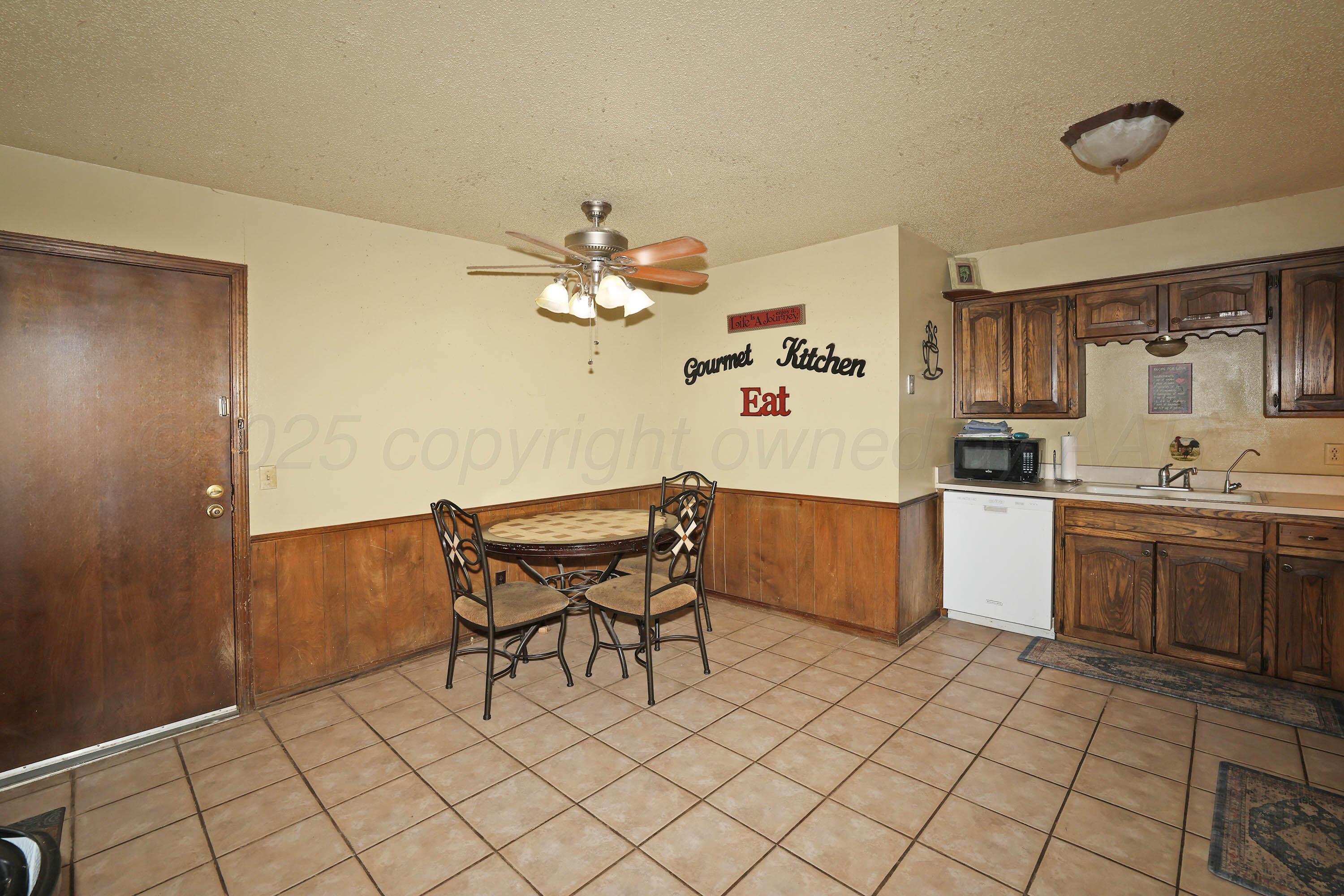6225-6227 Belpree Road Amarillo, TX 79106 - Photo 6 of 31 a kitchen with a sink cabinets and window