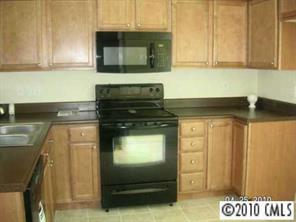412 Danielle Way Fort Mill, SC 29715 - Photo 6 of 8 a kitchen with granite countertop cabinets and black appliances