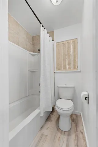 a bathroom with a toilet and a shower