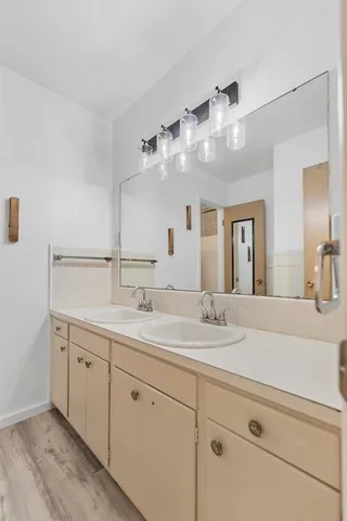 a bathroom with a sink double vanity and a mirror