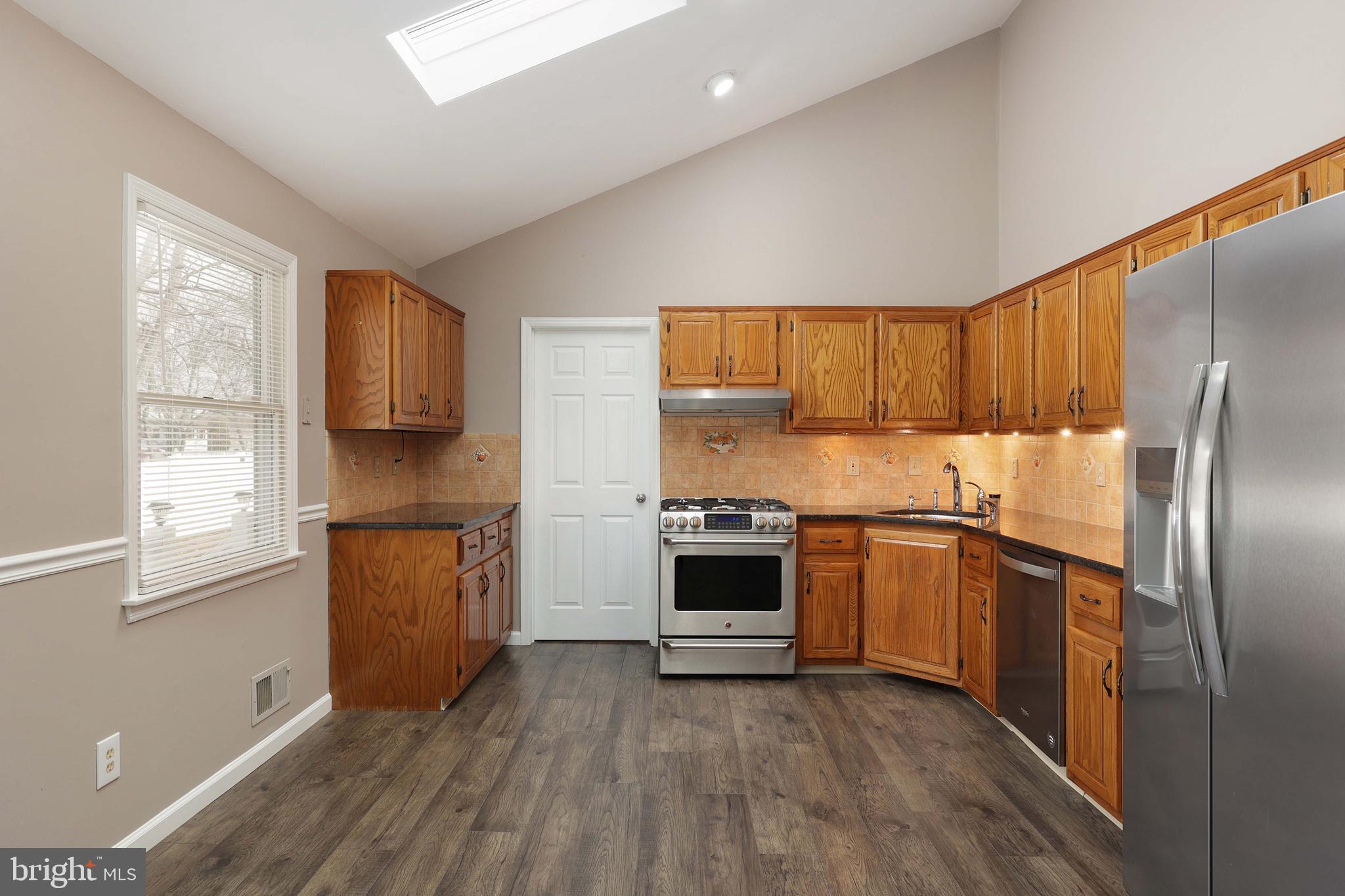 285 Manor Boulevard Hamilton, NJ 08620 - Photo 12 of 35 a kitchen with granite countertop a refrigerator stove top oven and sink