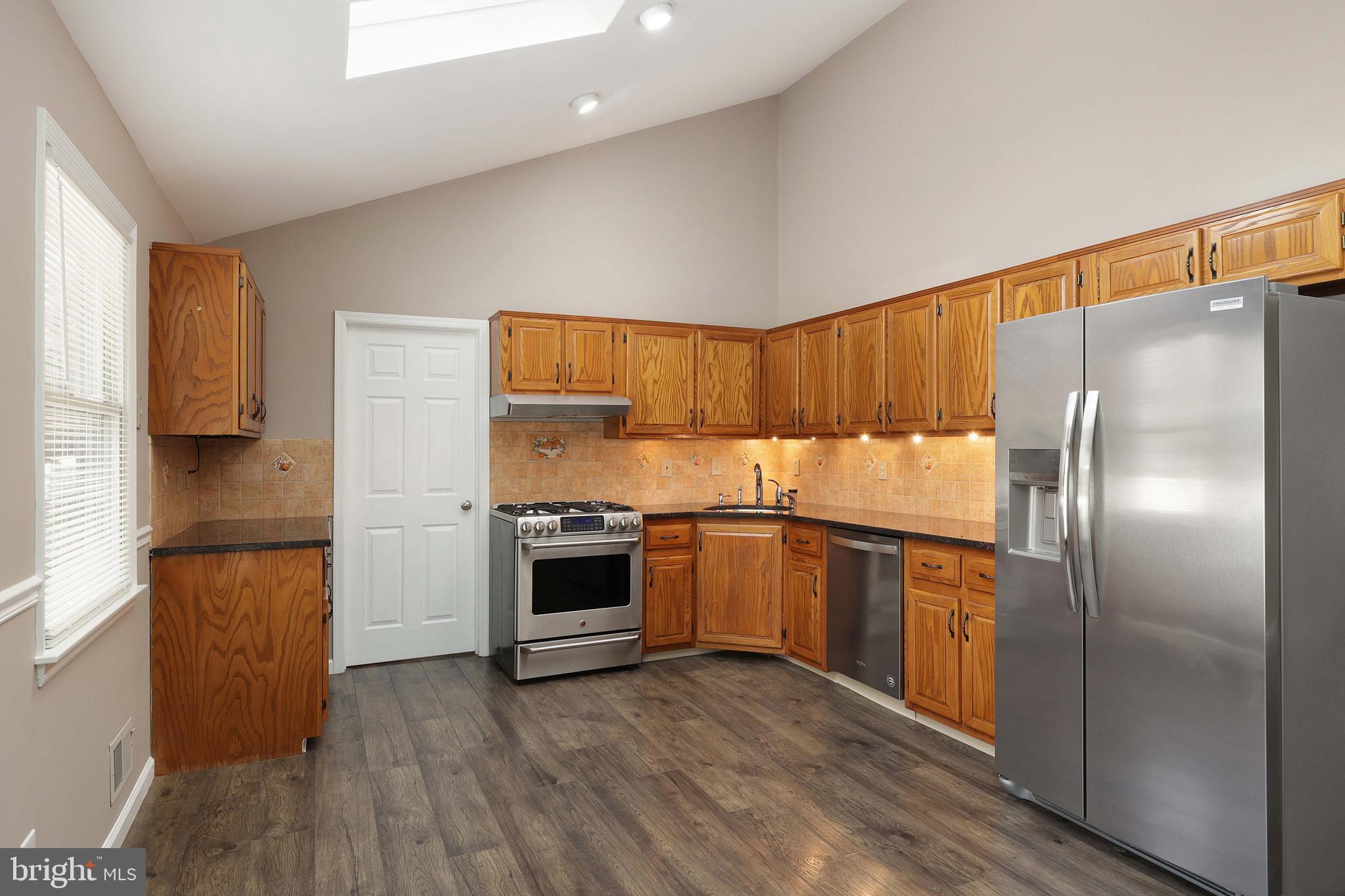 285 Manor Boulevard Hamilton, NJ 08620 - Photo 13 of 35 a kitchen with granite countertop stainless steel appliances a refrigerator and a stove top oven