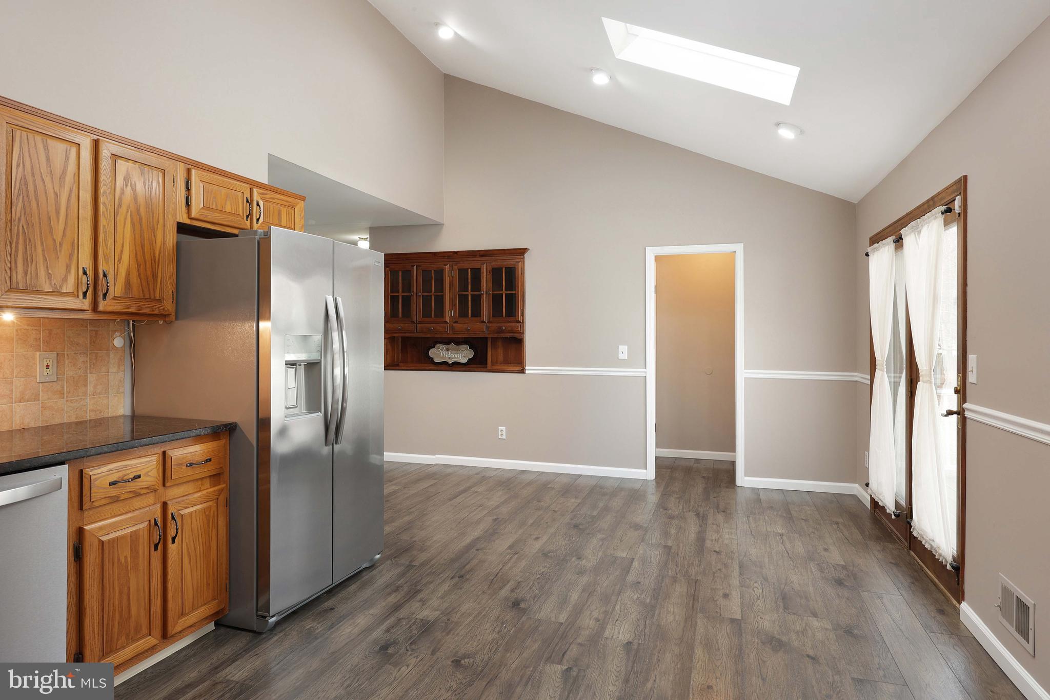 285 Manor Boulevard Hamilton, NJ 08620 - Photo 15 of 35 a view of a kitchen with refrigerator and wooden cabinets