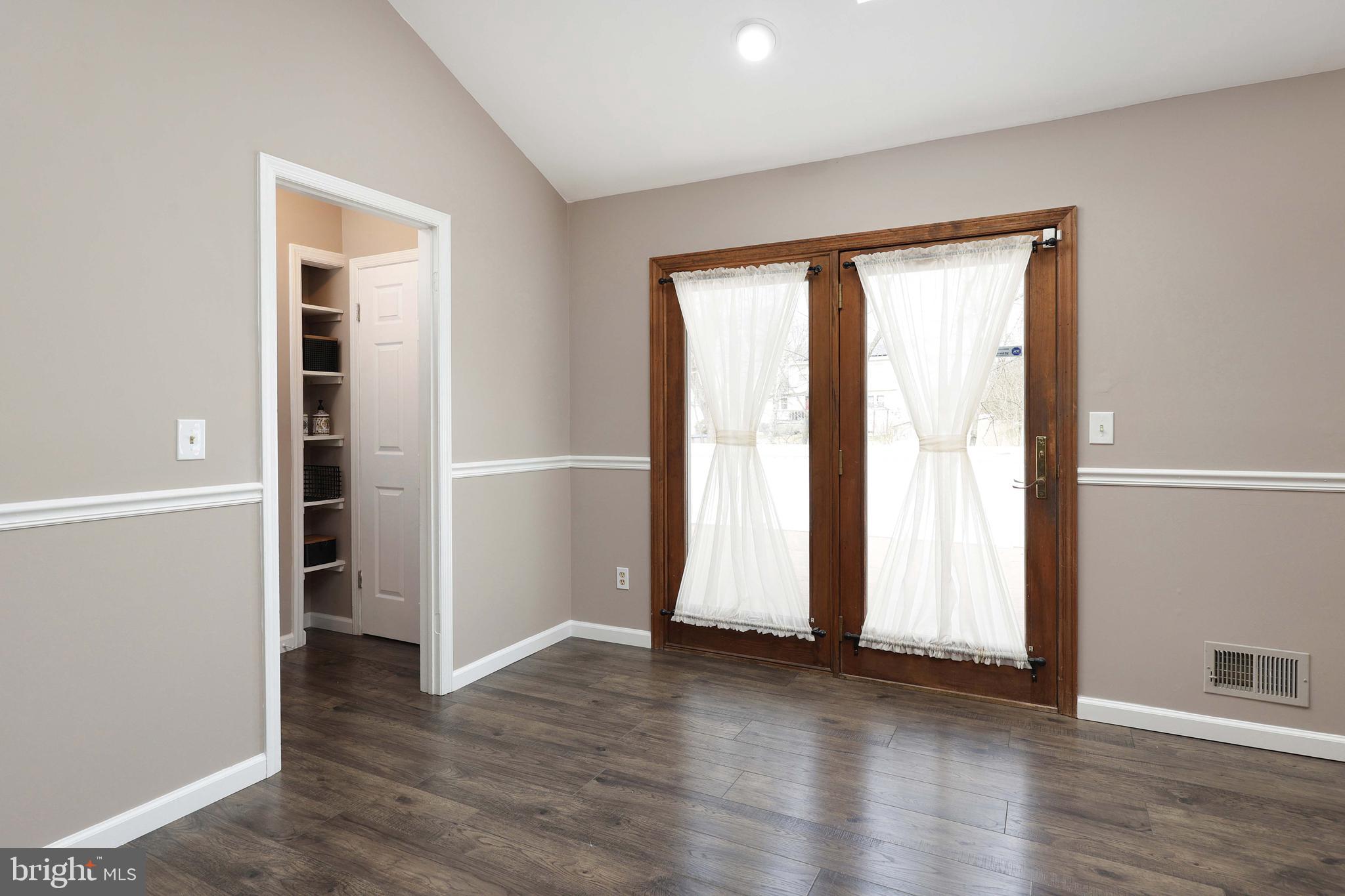 285 Manor Boulevard Hamilton, NJ 08620 - Photo 17 of 35 an empty room with wooden floor and windows
