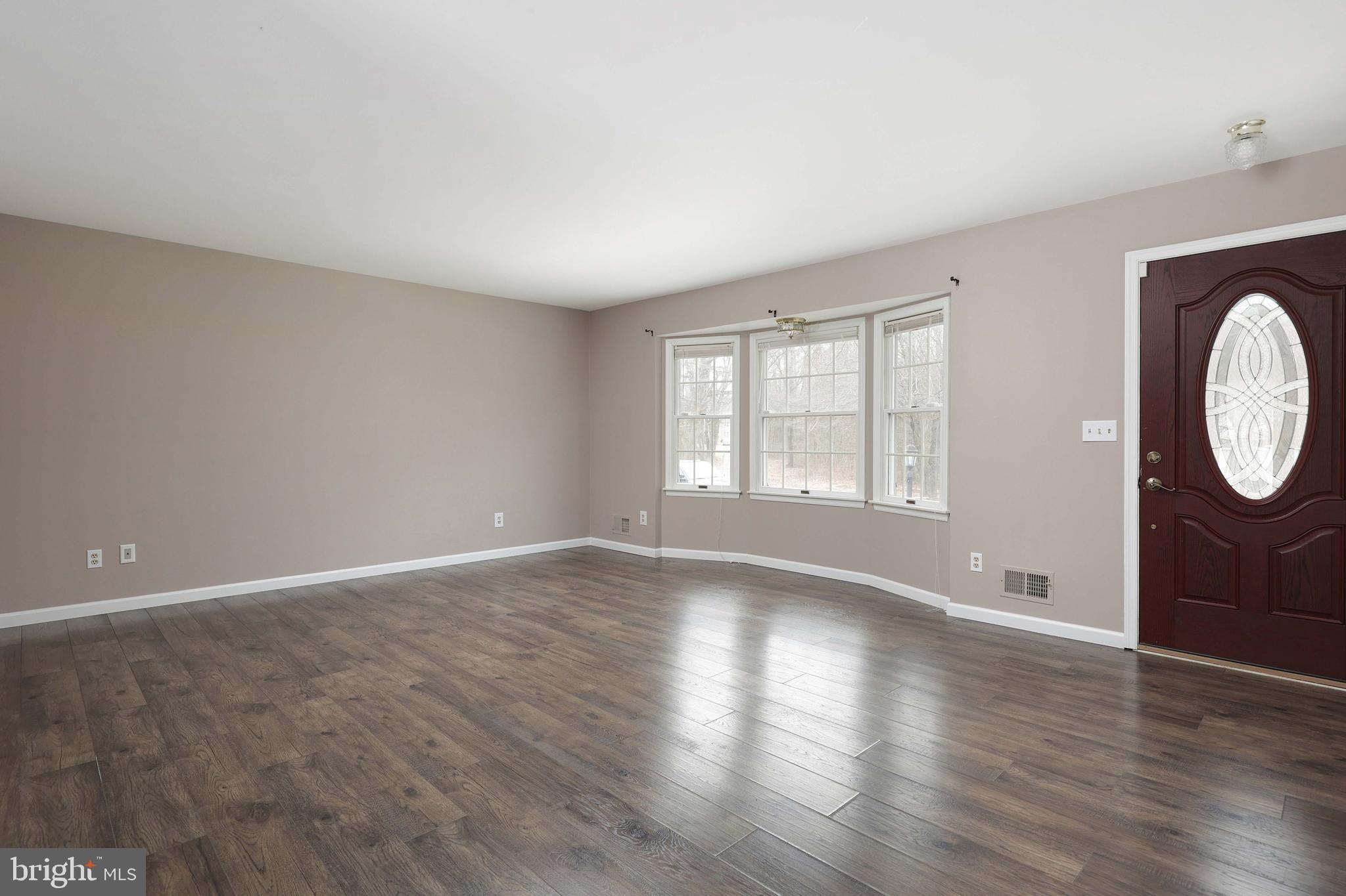 285 Manor Boulevard Hamilton, NJ 08620 - Photo 5 of 35 a view of an empty room with wooden floor and window