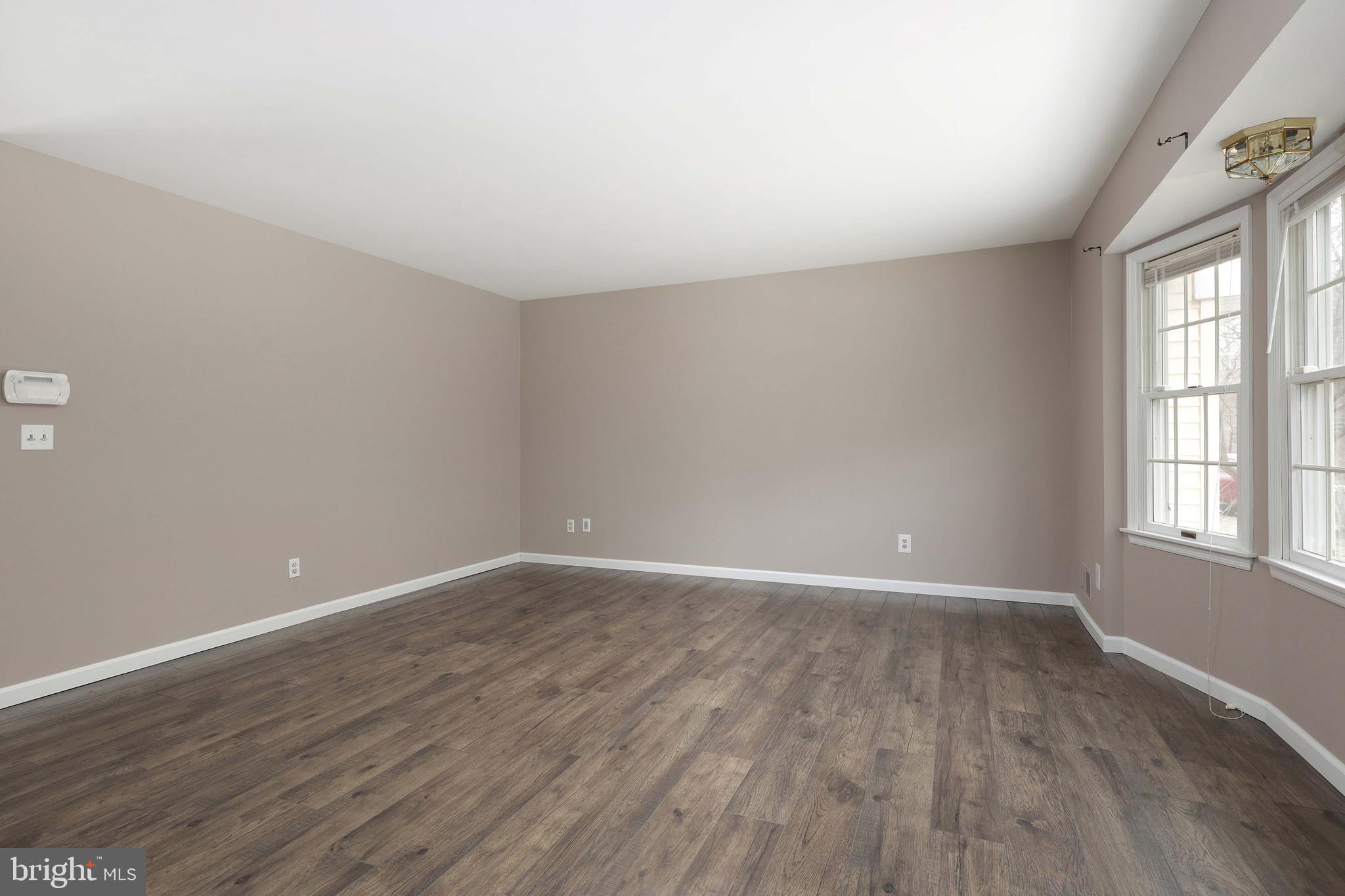 285 Manor Boulevard Hamilton, NJ 08620 - Photo 6 of 35 wooden floor in an empty room with a window