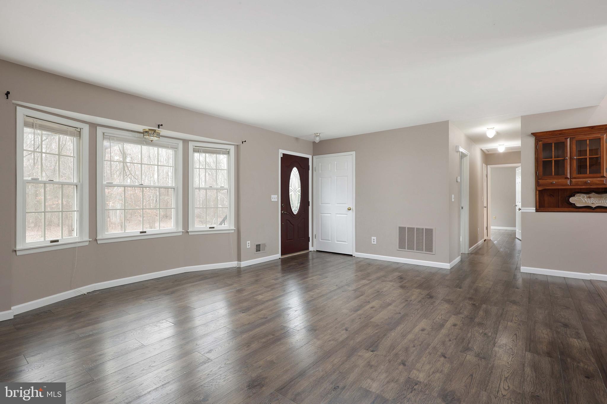 285 Manor Boulevard Hamilton, NJ 08620 - Photo 7 of 35 an empty room with wooden floor and windows