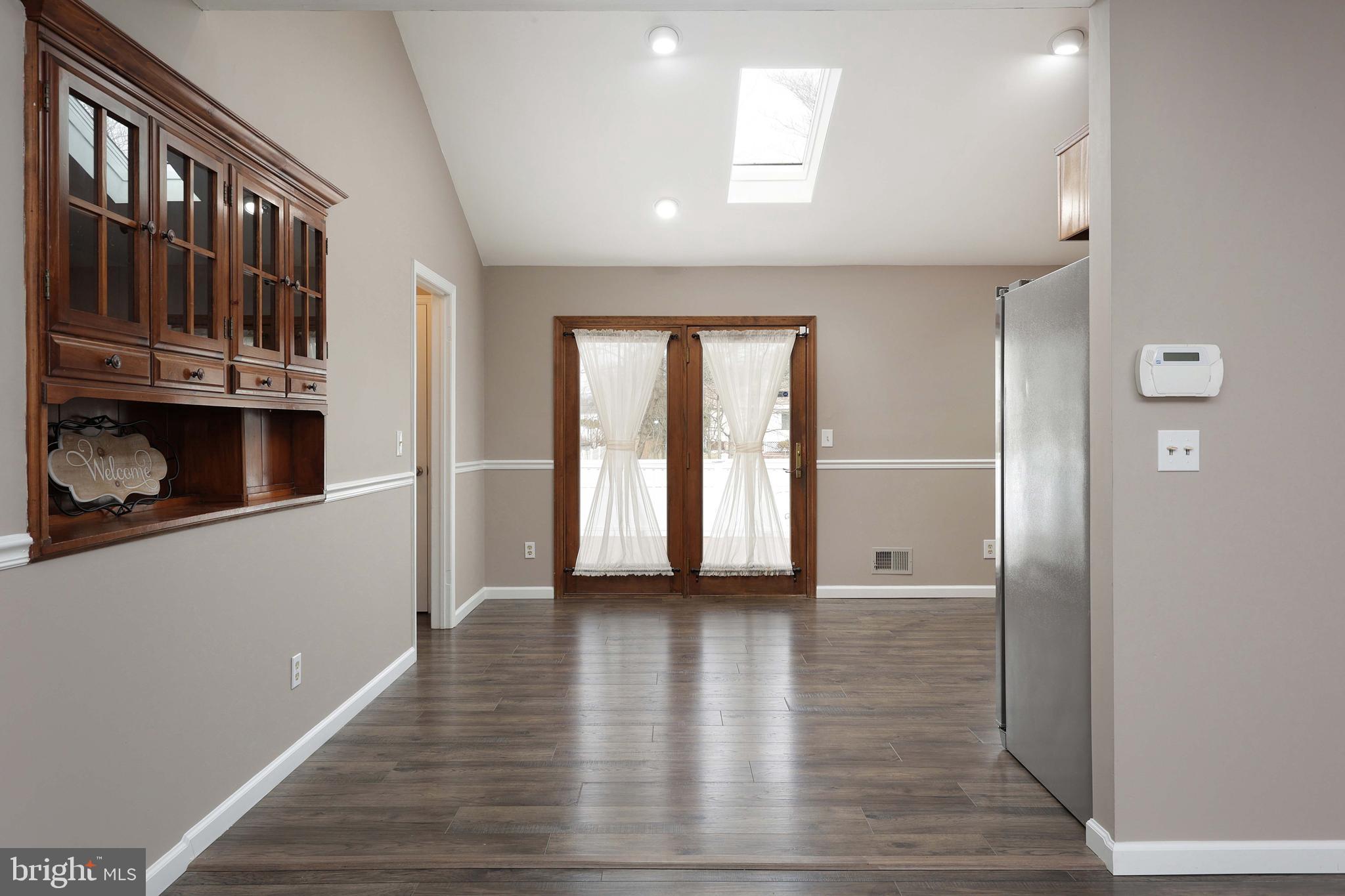 285 Manor Boulevard Hamilton, NJ 08620 - Photo 8 of 35 a view of an empty room with wooden floor and a window