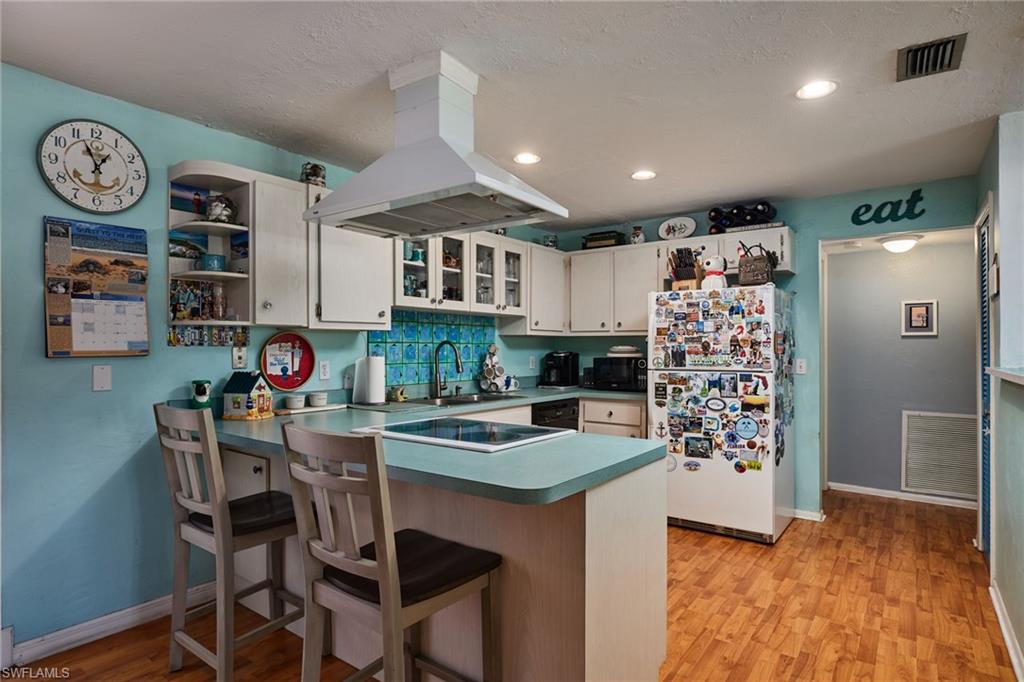1660 South Hermitage Road Fort Myers, FL 33919 - Photo 11 of 21 a kitchen with stainless steel appliances granite countertop a refrigerator and a stove top oven