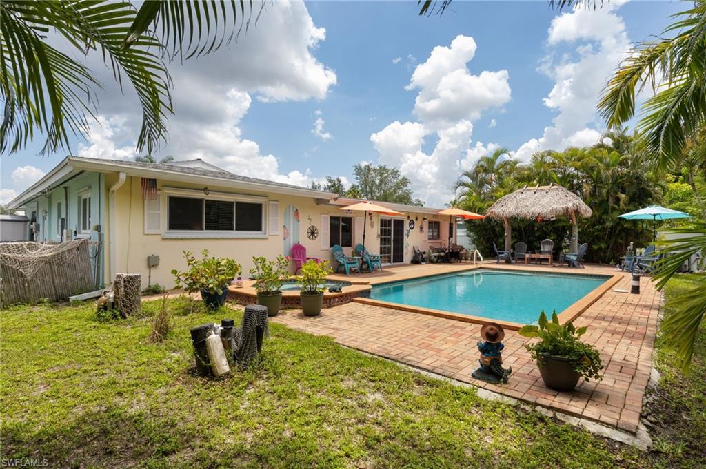 1660 South Hermitage Road Fort Myers, FL 33919 - Photo 2 of 21 a swimming pool with outdoor seating yard and barbeque oven