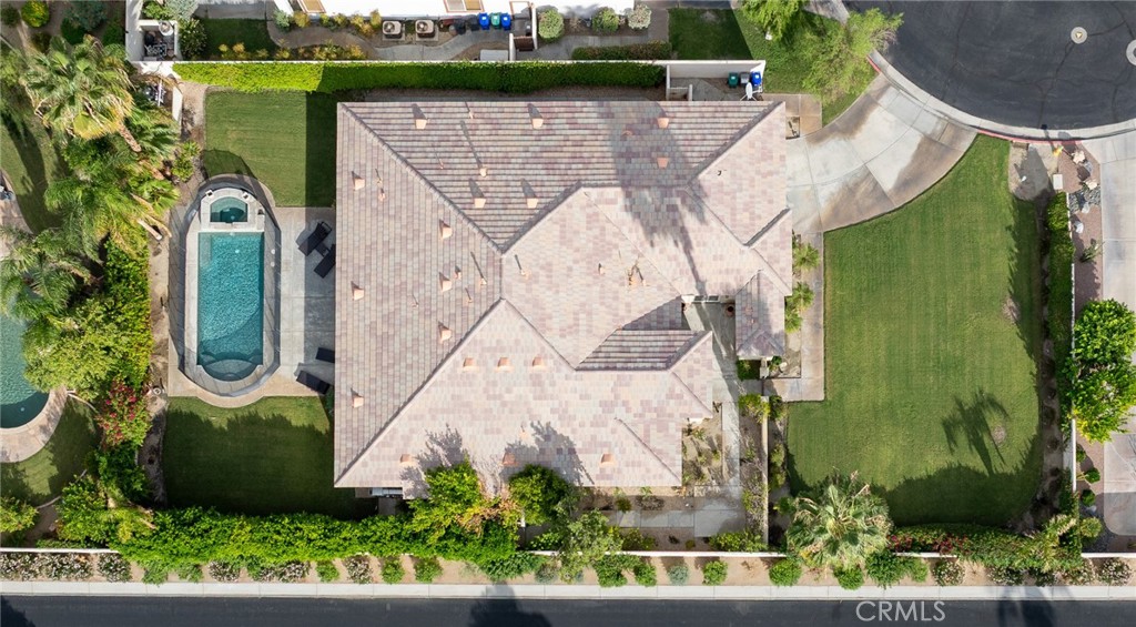 an aerial view of a house with a garden and trees