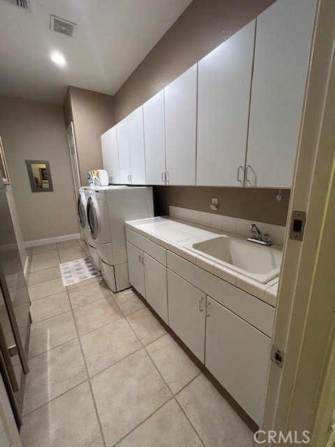 17 Bellisimo Court Rancho Mirage, CA 92270 - Photo 30 of 41 Laundry room with storage cabinets and sink