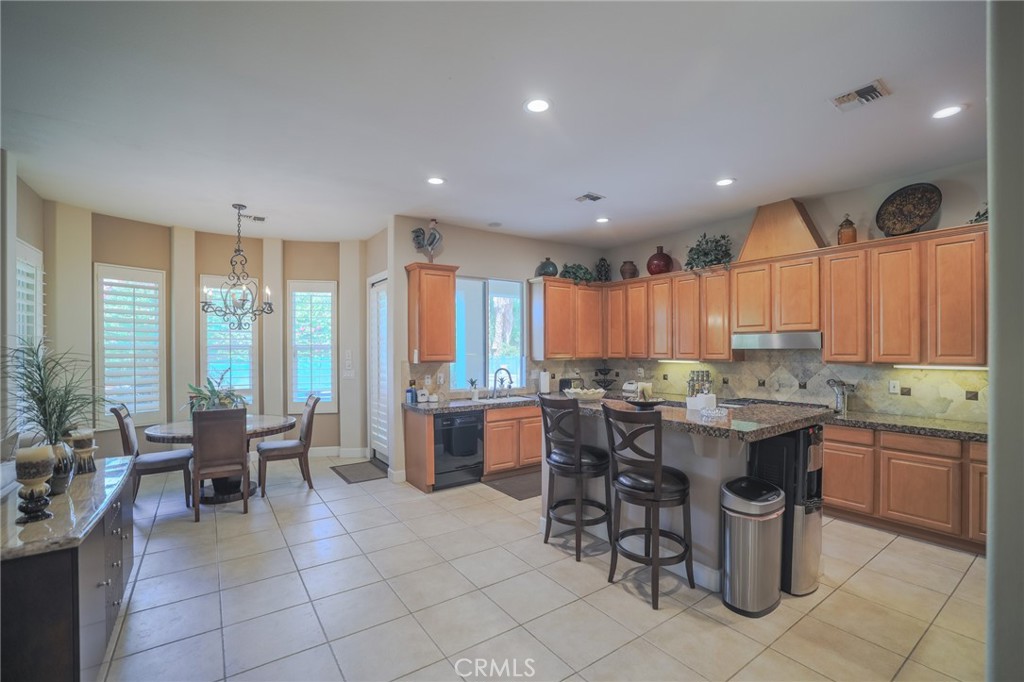 17 Bellisimo Court Rancho Mirage, CA 92270 - Photo 5 of 41 a kitchen with a large counter top space appliances and windows