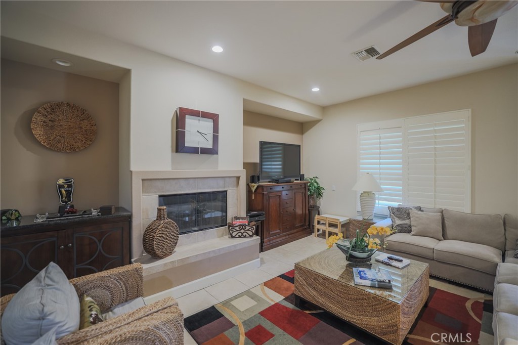 17 Bellisimo Court Rancho Mirage, CA 92270 - Photo 9 of 41 a living room with furniture a fireplace and a flat screen tv