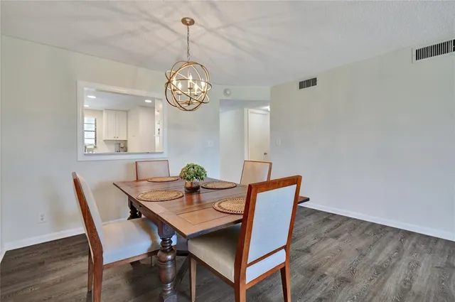 a view of a dining room with a table and chairs