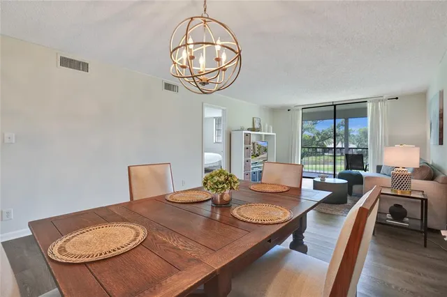 a view of a dining room with furniture wooden floor and chandelier