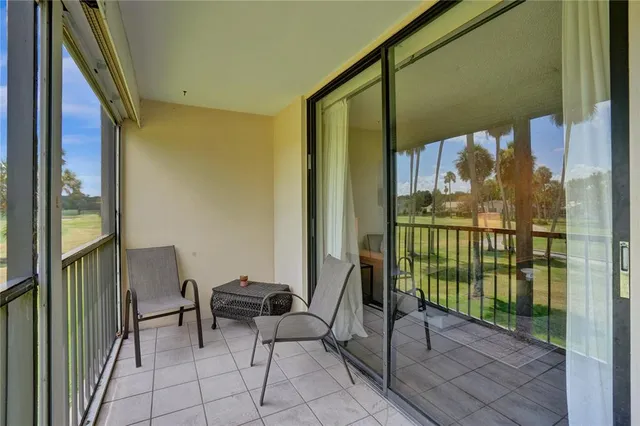 a view of a porch with a table and chairs