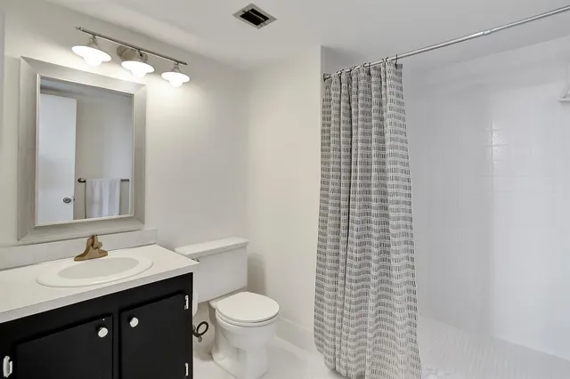 a bedroom with a bed and a night stand