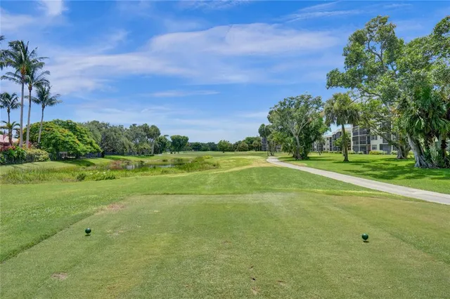 a view of a house with a big yard and large trees