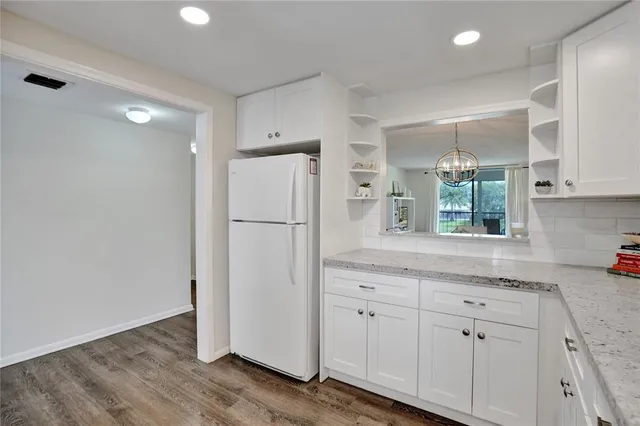 a kitchen with a refrigerator and a sink