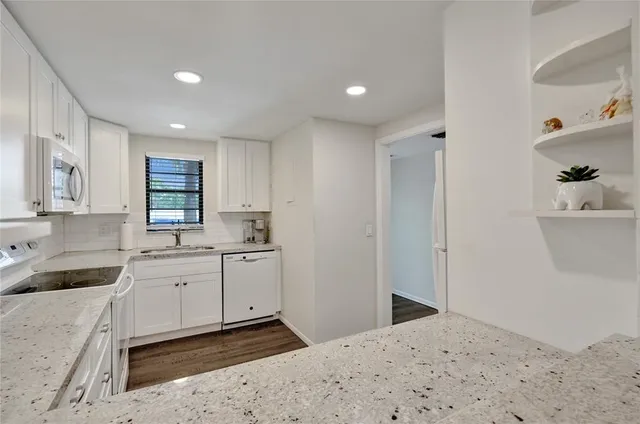 a kitchen with a sink cabinets and window
