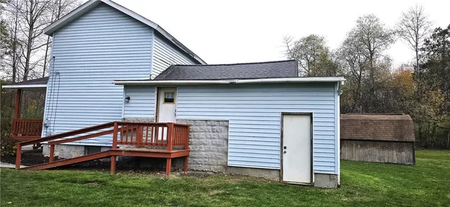 a view of a house with a yard and wooden fence