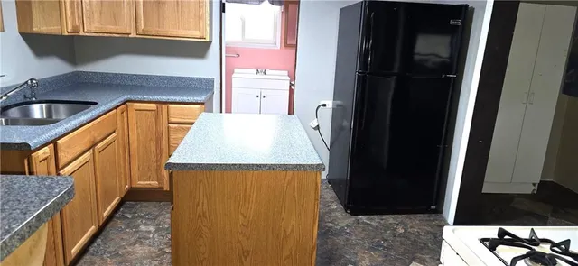 a view of a kitchen from a hallway