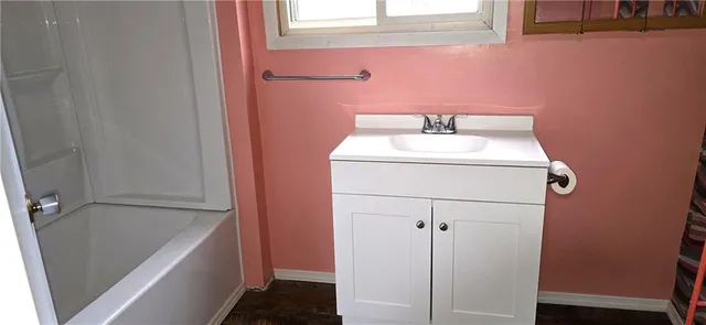 a bathroom with a sink and mirror