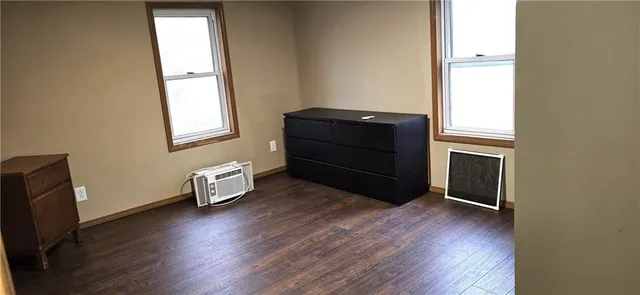 a room with a window and wooden floor