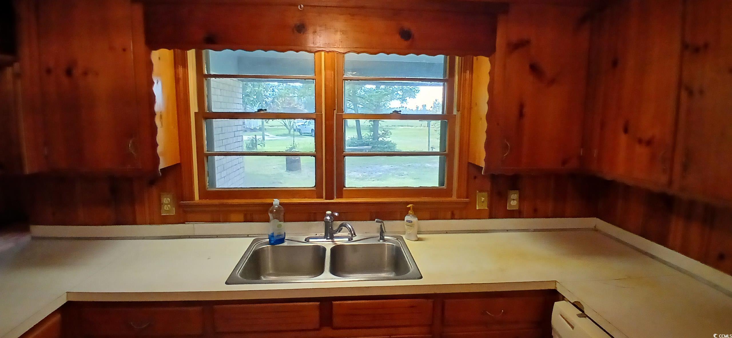 1206 French Road Mullins, SC 29574 - Photo 19 of 31 Kitchen with light countertops, brown cabinetry, and a baseboard heating unit