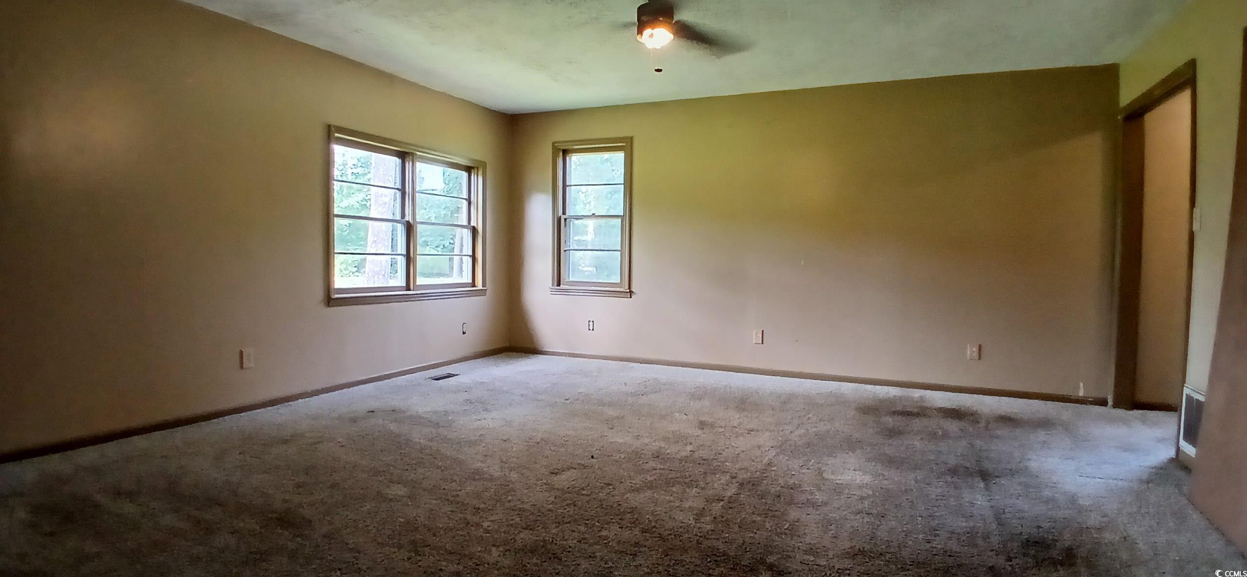 1206 French Road Mullins, SC 29574 - Photo 23 of 31 Carpeted spare room featuring baseboards and ceiling fan