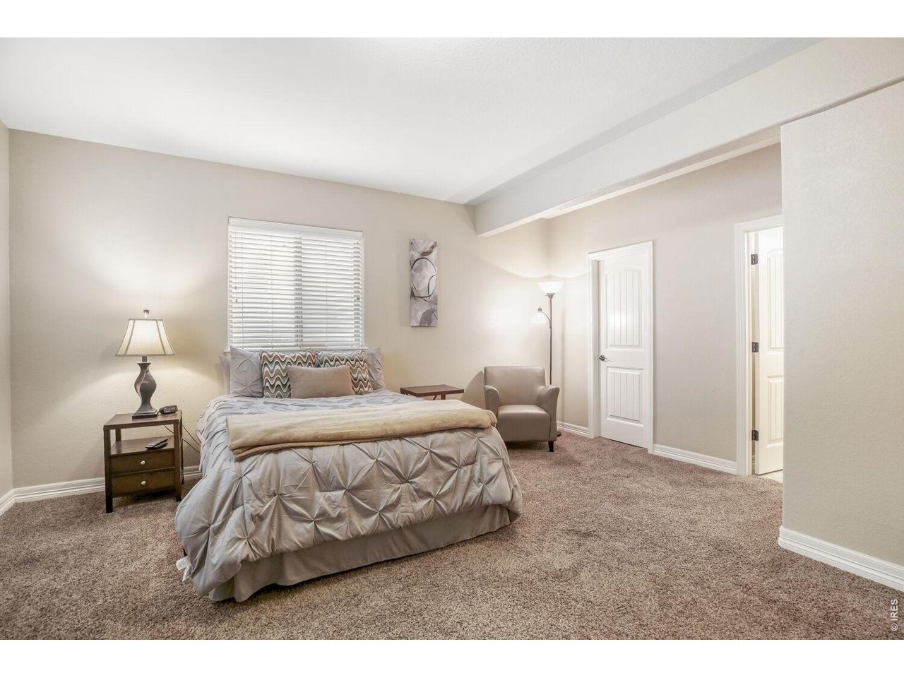 7992 St Street Frederick, CO 80530 - Photo 17 of 28 a bedroom with a bed and a night lamp