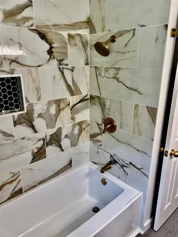 a bath tub sitting next to a white sink and vanity