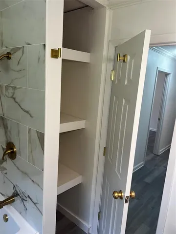 a view of a room with wooden floor and window