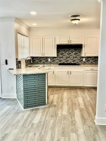 a kitchen with stainless steel appliances granite countertop a sink stove and cabinets