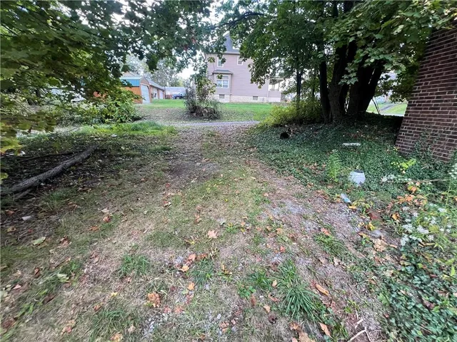 a view of a house with yard and a tree