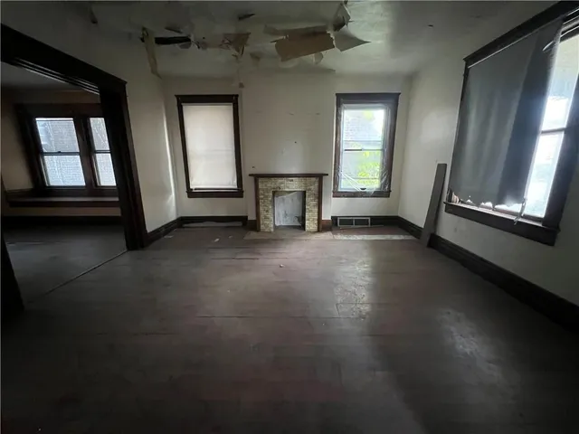 an empty room with windows and closet