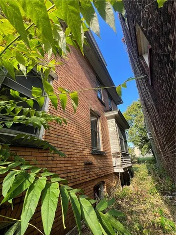 a front view of house with a garden