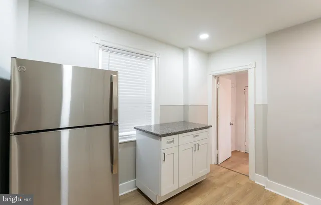 a kitchen with stainless steel appliances granite countertop a refrigerator a sink and a stove