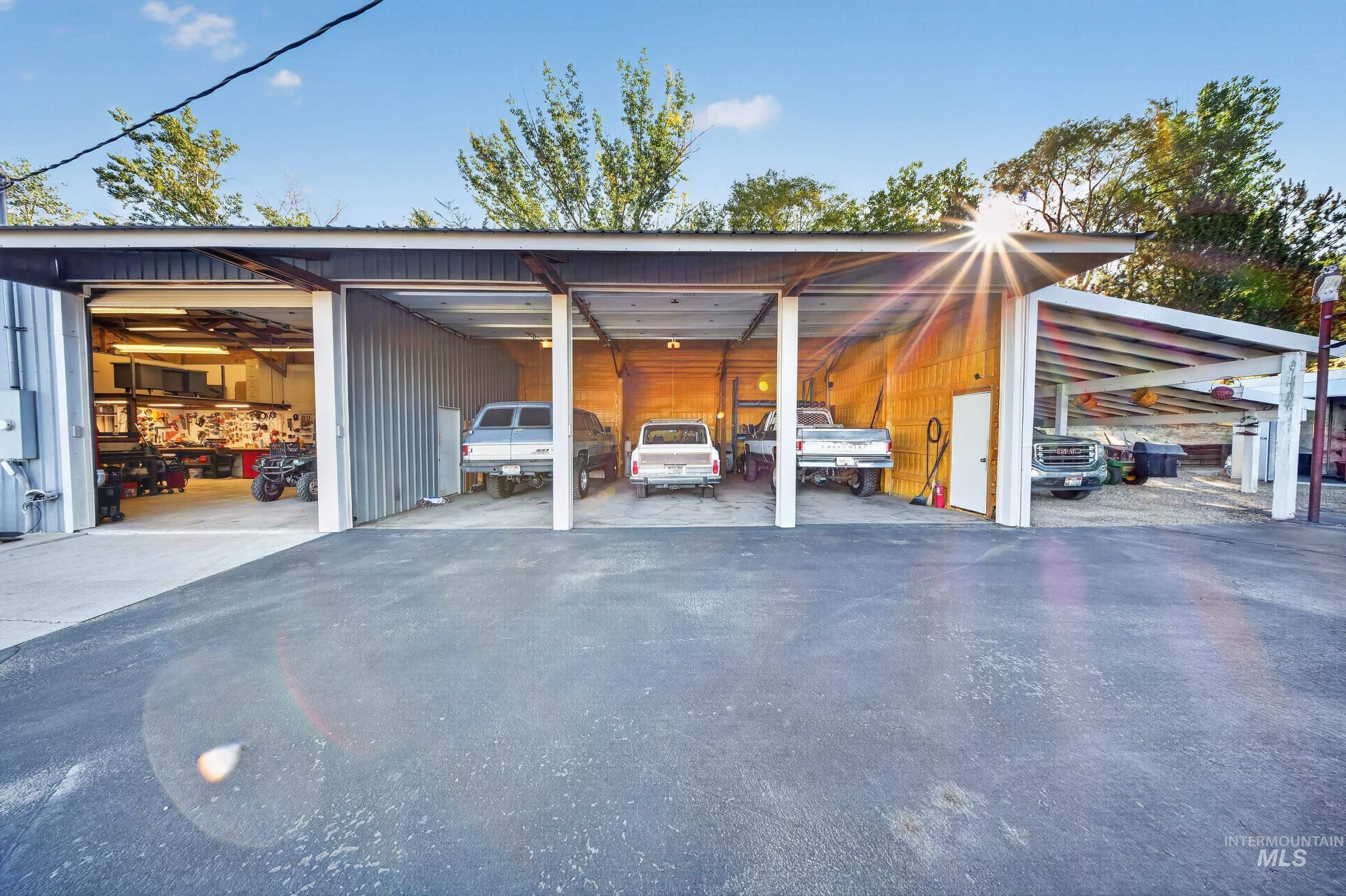 5540 Finley Road Fruitland, ID 83619 - Photo 46 of 50 Multi-bay metal structure with a covered parking area, paved asphalt, and overhead lighting