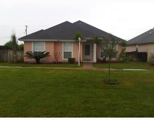 a view of a house with a backyard