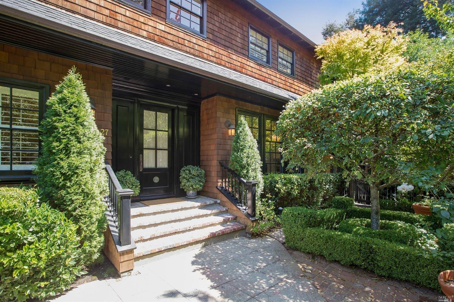 a front view of a house with a garden
