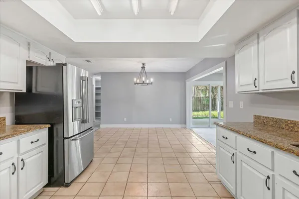 a kitchen with stainless steel appliances granite countertop a refrigerator and a sink